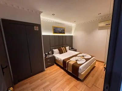 a bedroom with a bed with towels on it at Blue Istanbul Hotel Taksim in Istanbul