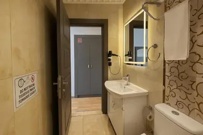 a bathroom with a sink and a toilet and a mirror at Blue Istanbul Hotel Taksim in Istanbul