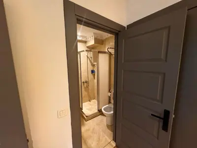 a door to a bathroom with a toilet and a shower at Blue Istanbul Hotel Taksim in Istanbul