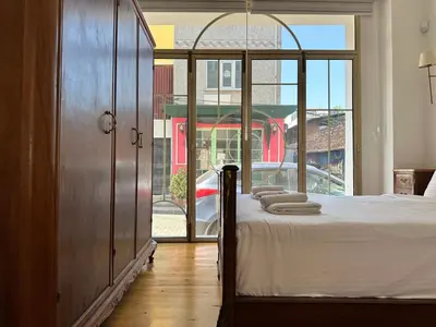 a bedroom with a bed and a large window at Balatella Suites in Istanbul