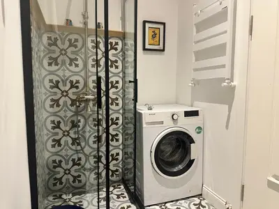 a washer and dryer in a bathroom with a door at Balatella Suites in Istanbul