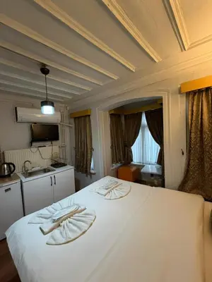 a bedroom with a white bed with two towels on it at Grey House Apartments B Block in Istanbul