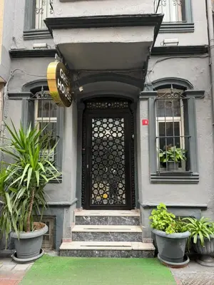 a front door of a house with potted plants at Grey House Apartments B Block in Istanbul