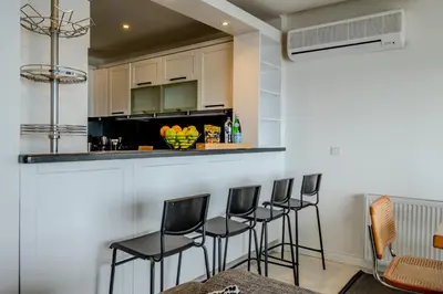 a kitchen with black chairs and a counter at Bosphorus View with 3 Bedrooms and 2 Bathrooms in Istanbul