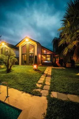 a home with a lit up backyard at night at Deep Luxury Sapanca in Sapanca