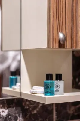 a shelf with two bottles of soap and a mirror at CANPOLAT Sapanca Hotel in Sapanca