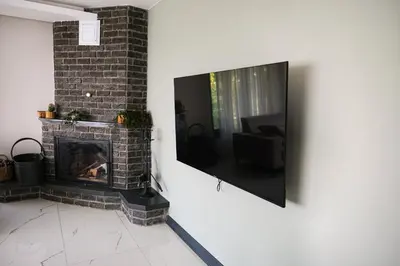 a living room with a fireplace and a flat screen tv at Adesa View Villas in Sapanca