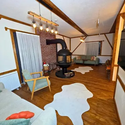 a living room with a wood stove in a room at Uludag Zirve Garden - BBQ Jacuzzi