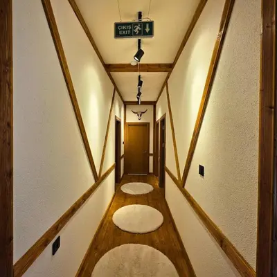 a hallway with three rugs on the floor of a room at Uludag Zirve Garden - BBQ Jacuzzi