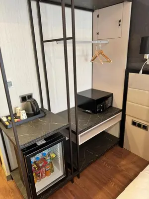 a kitchen with a refrigerator with a counter top at Gnc Airport Hotel in Arnavutköy