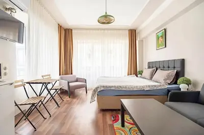 a bedroom with a bed and a living room at 1st Floor Historic Flat in Old Istanbul in Istanbul