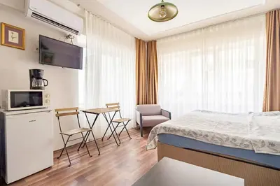 a bedroom with a bed and a table with chairs at 1st Floor Historic Flat in Old Istanbul in Istanbul