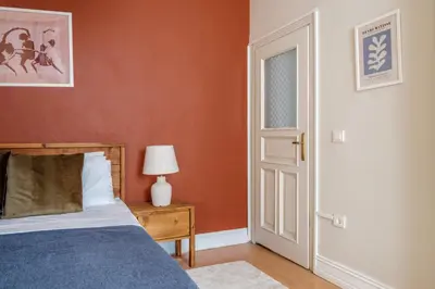 a bedroom with a bed and an open door at Urban Balcony Suite - Close to Taksim in Istanbul