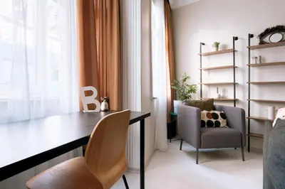 a room with a desk and chairs and a window at Stylish Flat w Balcony – 5 Mins from Taksim Square in Istanbul