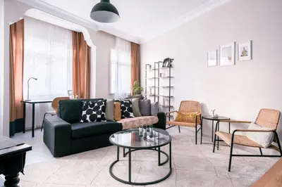 a living room with a couch and a table at Stylish Flat w Balcony – 5 Mins from Taksim Square in Istanbul
