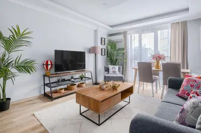 a living room with a tv and a table at Newly Built in Sisli • Fast WiFi • Elevator in Istanbul