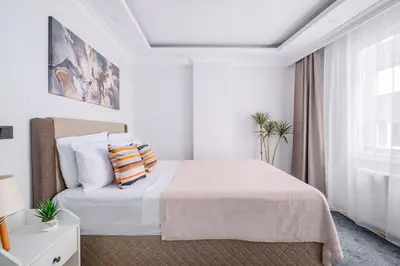 a white bedroom with a bed and a window at Newly Built in Sisli • Fast WiFi • Elevator in Istanbul