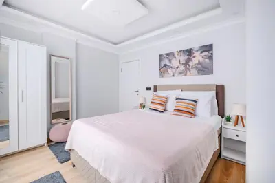 a white bedroom with a large bed with two pillows at Newly Built in Sisli • Fast WiFi • Elevator in Istanbul