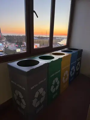 three recycle bins sitting in front of a window at Otel Parpali in Istanbul
