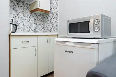 a kitchen with a microwave and a tv on a counter at Kadirga Studios in Istanbul