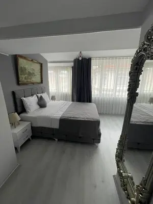 a bedroom with a large bed and a mirror at Oldmile Palace Hotel in Istanbul