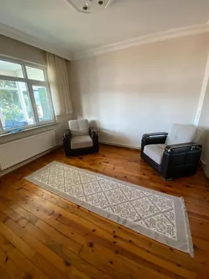 a living room with two chairs and a rug at bahçeli ve göl manzaralı ev in Sapanca