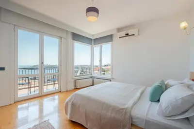a bedroom with a large bed and large windows at Bosphorus View with 5 Bedrooms and Elevator in Istanbul