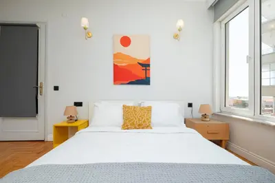 a bedroom with a white bed and two windows at Bosphorus View with 5 Bedrooms and Elevator in Istanbul