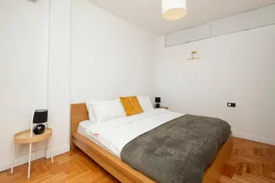 a bedroom with a bed with white walls and wooden floors at Bosphorus View with 5 Bedrooms and Elevator in Istanbul