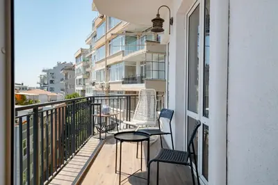a balcony with chairs and a table on a building at Bosphorus View with 5 Bedrooms and Elevator in Istanbul