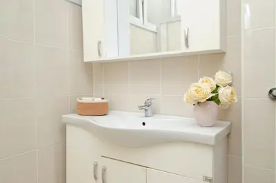 a bathroom with a sink and flowers in a vase at Bosphorus View with 5 Bedrooms and Elevator in Istanbul