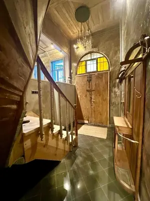 a large bathroom with a wooden door and a staircase at Balat Istanbul Three-Story Restored Ottoman House in Istanbul