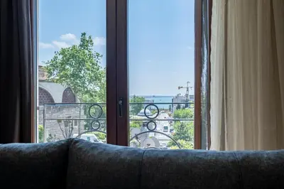a couch in front of a window with a view at Spacious One Bedroom Apartment with View and Elevator in Istanbul