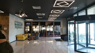 a lobby with a yellow couch in a building at Empire Hotel İstanbul in Istanbul