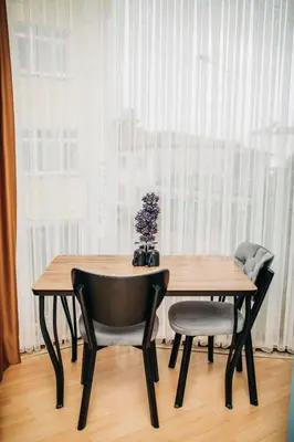 a dining room table and two chairs with a window at Ekinoks Hotel in İznik