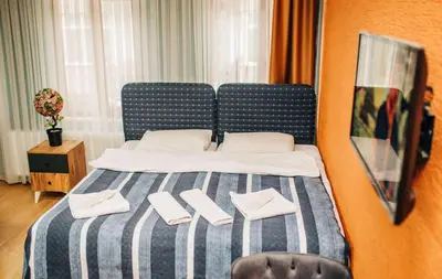 a bedroom with a bed with two pairs of slippers on it at Ekinoks Hotel in İznik