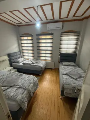 a room with three beds and a ceiling with windows at Taksim Of The City in Istanbul