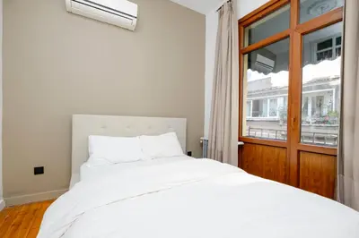 a bedroom with a white bed and a window at Private Building Featuring Two Separate Apartments in Istanbul