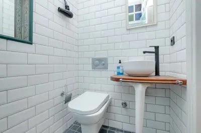 a white bathroom with a toilet and a sink at Private Building Featuring Two Separate Apartments in Istanbul