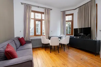 a living room with a couch and a table and chairs at Private Building Featuring Two Separate Apartments in Istanbul