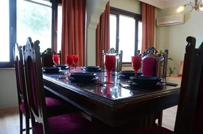 a dining room table with plates and glasses on it at Heart of Yesilkoy-Green village in Istanbul
