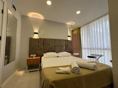 a bedroom with a large bed with two towels on it at Mall Off Palace in Istanbul