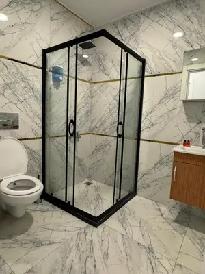 a bathroom with a glass shower with a toilet at Mall Off Palace in Istanbul