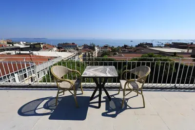 a table and two chairs on a balcony at New House Hotel in Istanbul