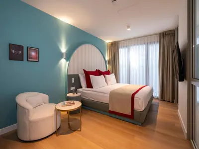 a hotel room with a bed and a chair at Taksim Juno Residences in Istanbul