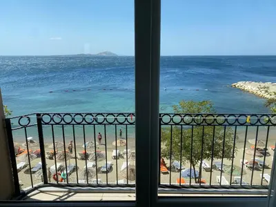 a view of a beach from a window of a balcony at Sato Hotel in Marmara