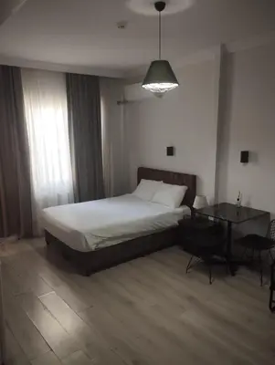 a bedroom with a bed and a table in it at Şişli Suites - Room 24 in Istanbul