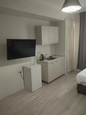a white kitchen with a sink and a microwave at Şişli Suites - Room 24 in Istanbul