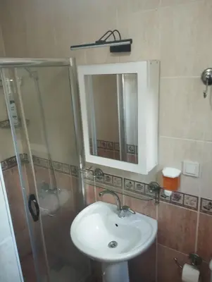 a bathroom with a sink and a shower and a mirror at Şişli Suites - Room 24 in Istanbul