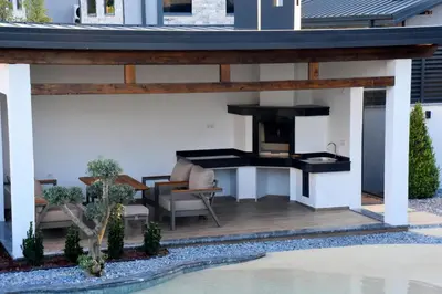 a patio with a fireplace in a house at maura beach villas family in Kartepe